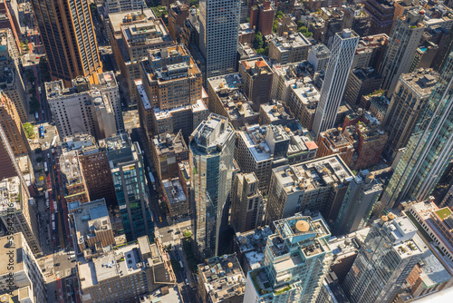 Beautiful top-down view of rooftops of skyscrapers in densely built-up Manhattan. New York, USA.