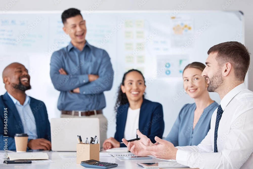 Fototapeta premium Diverse group of business people talking in a meeting and using technology and paperwork in a boardroom. Team of professionals sitting together, brainstorming and planning a strategy in the office