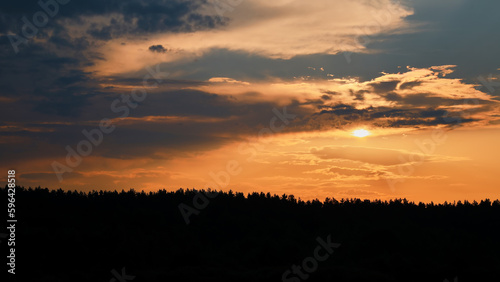Natural sunrise over forest. Bright red sky. Countryside landscape. Under scenic colorful sky at sunrise. © sergofan2015