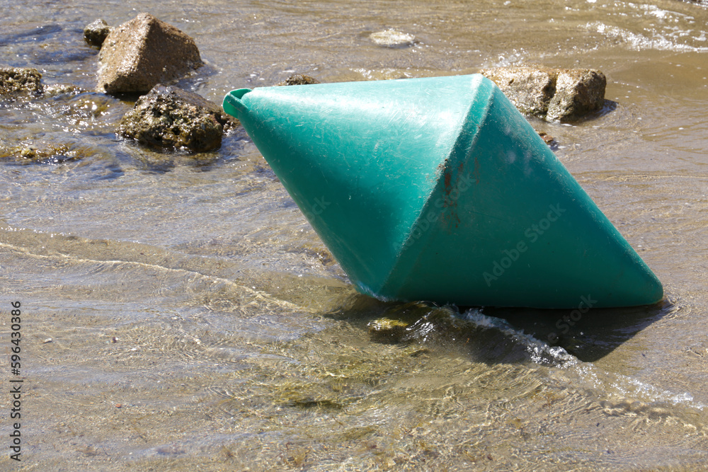 Green buoy on the shore of the beach Green buoy on the shore of the beach