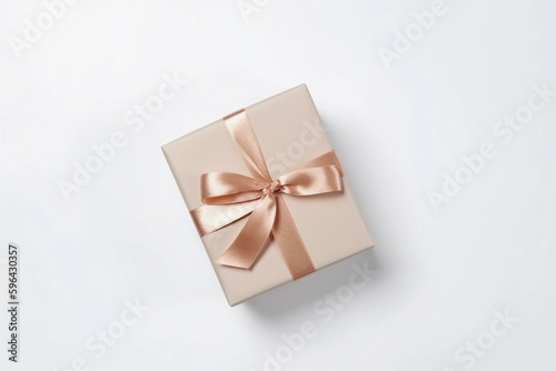 Gift box with satin ribbon and bow on whit background. Holiday gift with copy space. Birthday or Christmas present, flat lay, top view. Christmas giftbox concept