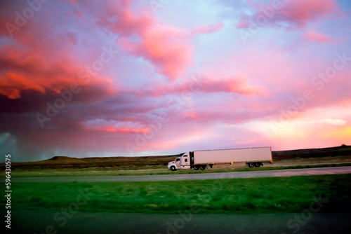 Semi 18 Wheel Diesel truck at dusk sunset with storm