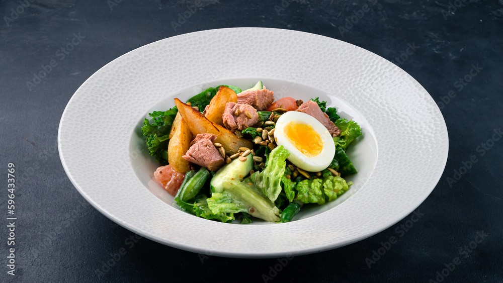 Fresh salad of fresh cucumber, tomatoes, lettuce, eggs, tuna fish and potato wedges. Fresh salad of fresh cucumber, tomatoes, lettuce, eggs, tuna fish and potato wedges.