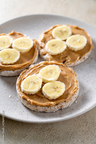 Rice cake with banana and peanut butter, healthy protein snack