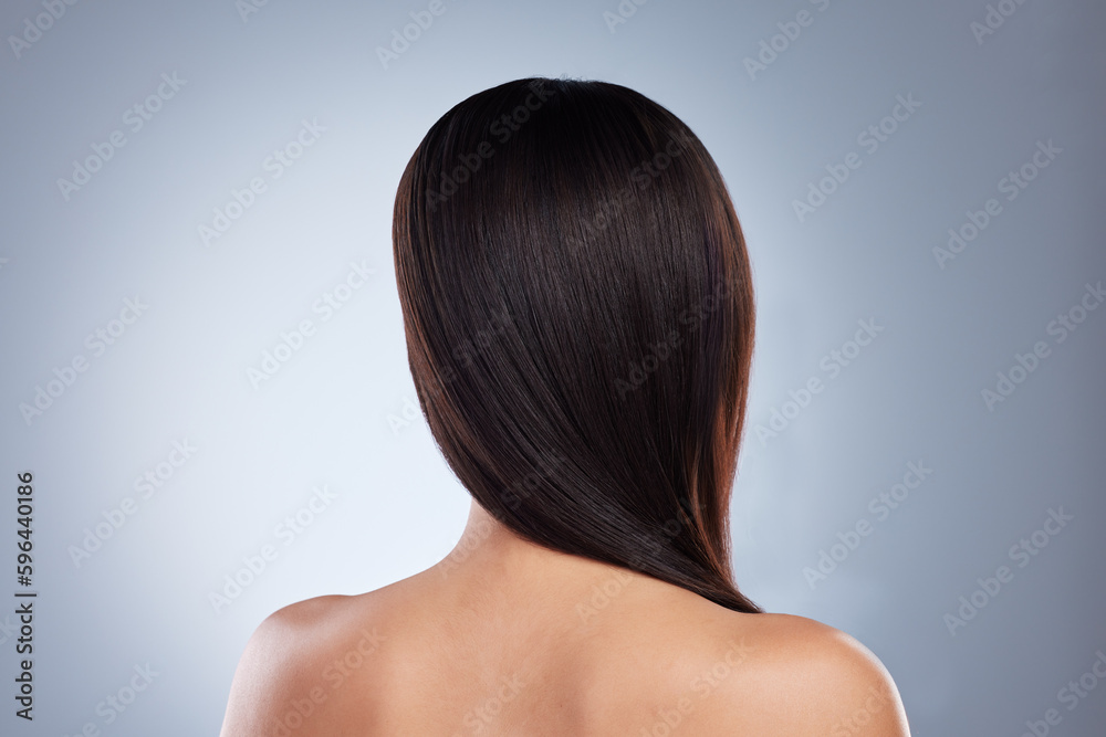 Rear view of brunette woman posing with her hair over her shoulder. Young mixed race woman with healthy smooth straight hair Rear view of brunette woman posing with her hair over her shoulder. Young mixed race woman with healthy smooth straight hair