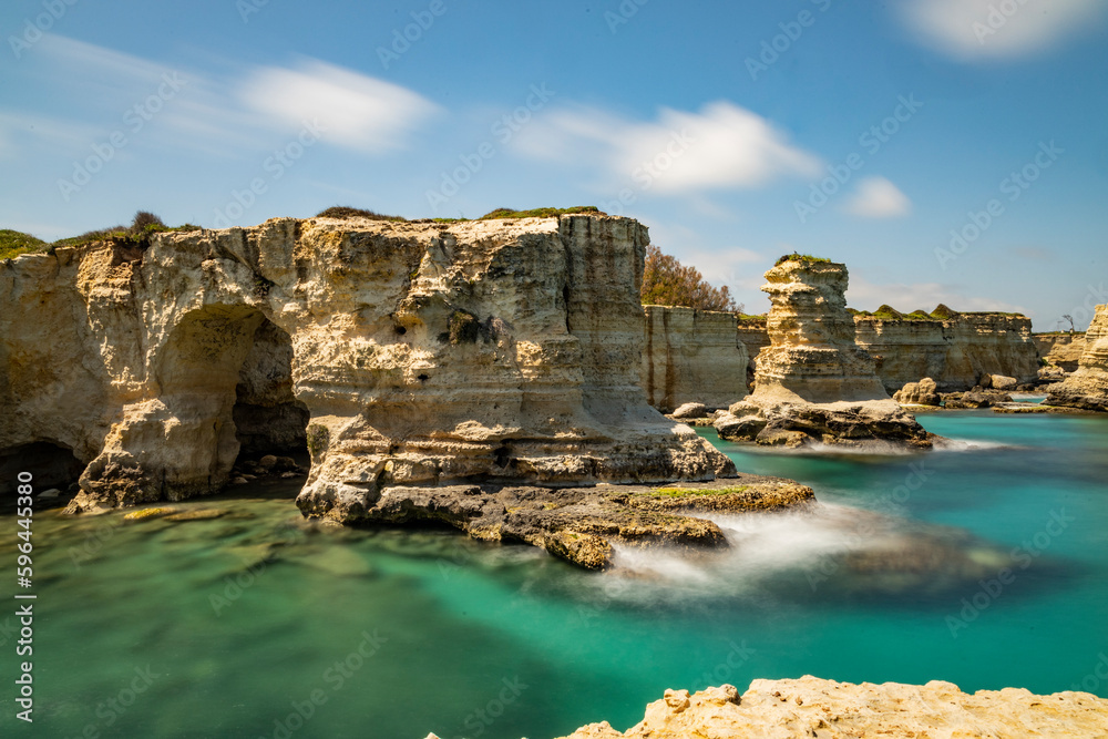 Faraglioni of Sant'Andrea, Puglia. Evocative spectacle, on a cliff overlooking the sea with caves, inlets and wild animals, in short, a world to discover. Long exposure during a windy day.