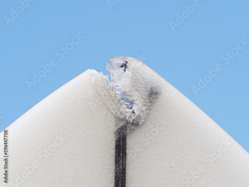 Damaged part on nose to repair on a surfboard.