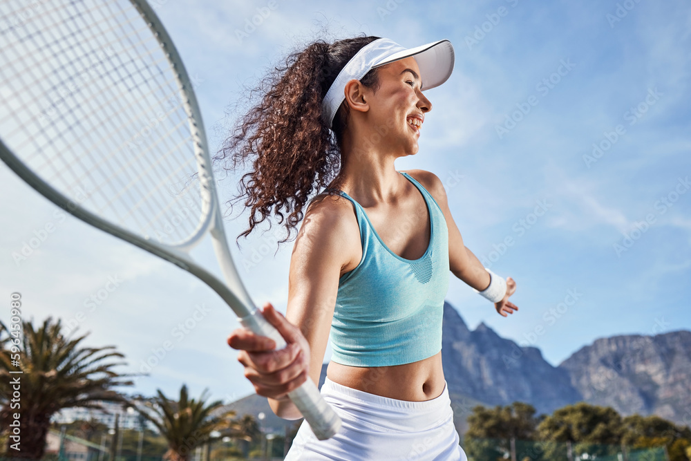 makes perfect. Shot of an attractive young alone and getting ready to hit the ball during a game of tennis. Stock Photo | Adobe Stock
