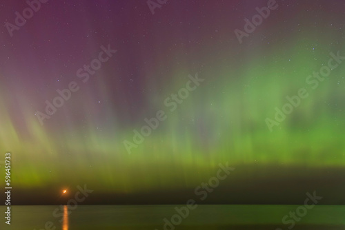 Aurora Borealis northen lights on the Baltic Sea beach at Jurmala, Latvia
