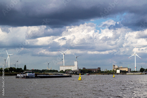 Wind turbines along the Scheldt river, Antwerp, Belgium.