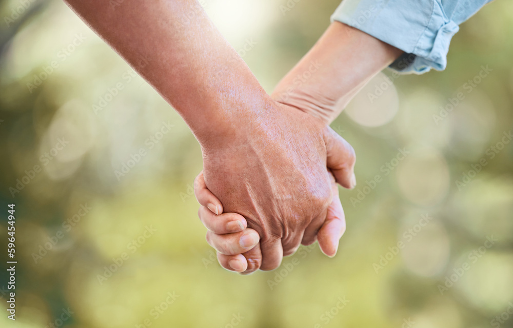 Walk through life with the one you love. Shot of an unrecognisable senior couple holding hands in a garden. Walk through life with the one you love. Shot of an unrecognisable senior couple holding hands in a garden.