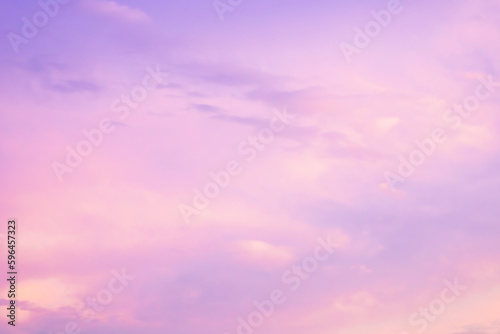Majestic dusk. Sunset sky twilight in the evening with colorful sunlight. Trendy colors of the 2022. Abstract nature background. Calm gentle pink, viotel, purple and yellow clouds.