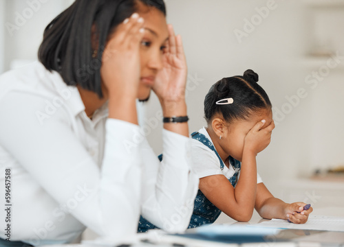 Im gonna lose it with this kid. Shot of a young mother looking frustrated while helping her daughter with homework at home.