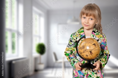 Cheerful student child with globe. School concept.