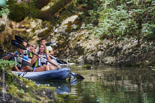 A group of friends enjoying having fun and kayaking while exploring the calm river, surrounding forest and large natural river canyons