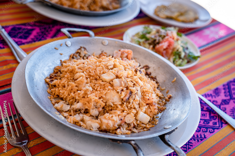 rice with shrimp on a metal pan and accompaniment from the Colombian tropics rice with shrimp on a metal pan and accompaniment from the Colombian tropics