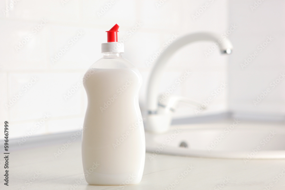 Dishwashing detergent on the background of the kitchen