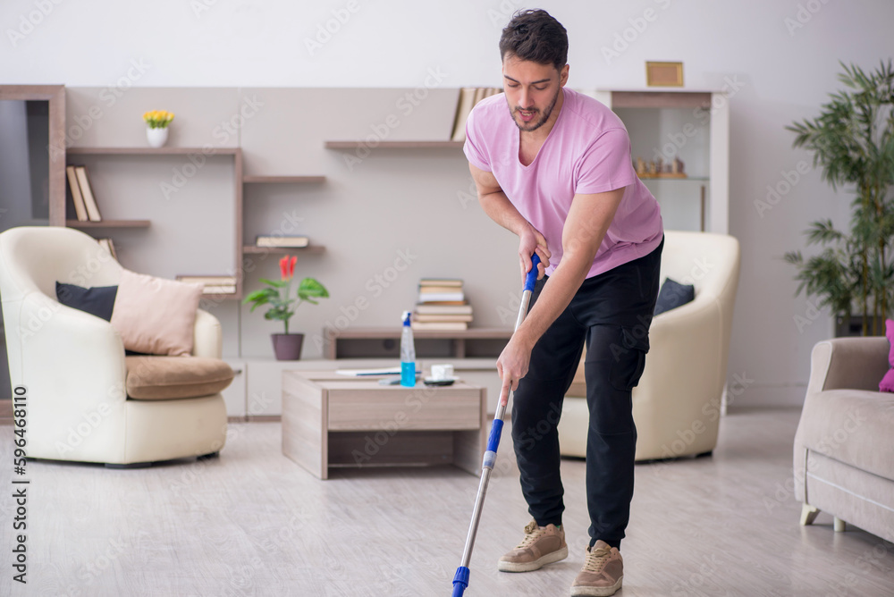 Young male contractor cleaning the house Young male contractor cleaning the house