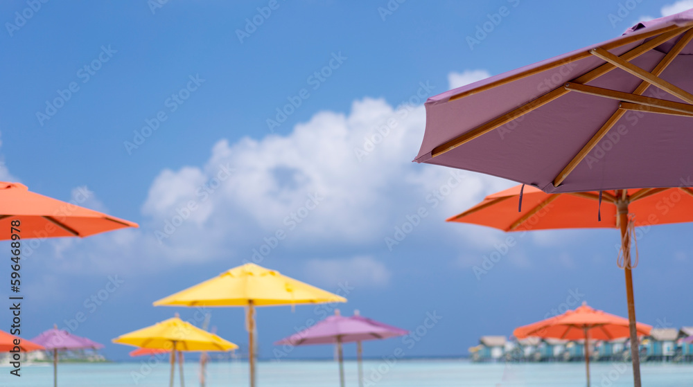 Multicolored beach umbrellas on the background of blue sky on the Maldives. Tropical resort
