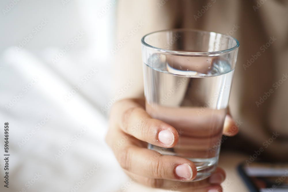 holding a glass of water with copy space holding a glass of water with copy space