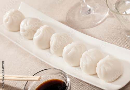 Dish of Asian cuisine - dim sum dumplings served on white plate photo