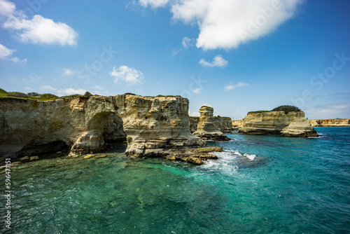 Faraglioni of Sant'Andrea, Puglia. Evocative spectacle, on a cliff overlooking the sea with caves, inlets and wild animals, in short, a world to discover. Long exposure during a windy day.