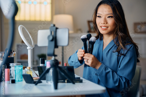 Asian beauty vlogger talks about make up brushers during her live stream.