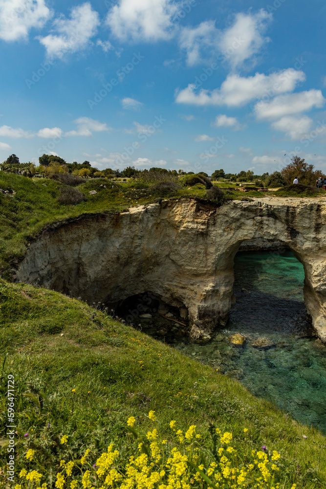Faraglioni of Sant'Andrea, Puglia. Evocative spectacle, on a cliff overlooking the sea with caves, inlets and wild animals, in short, a world to discover. Long exposure during a windy day.