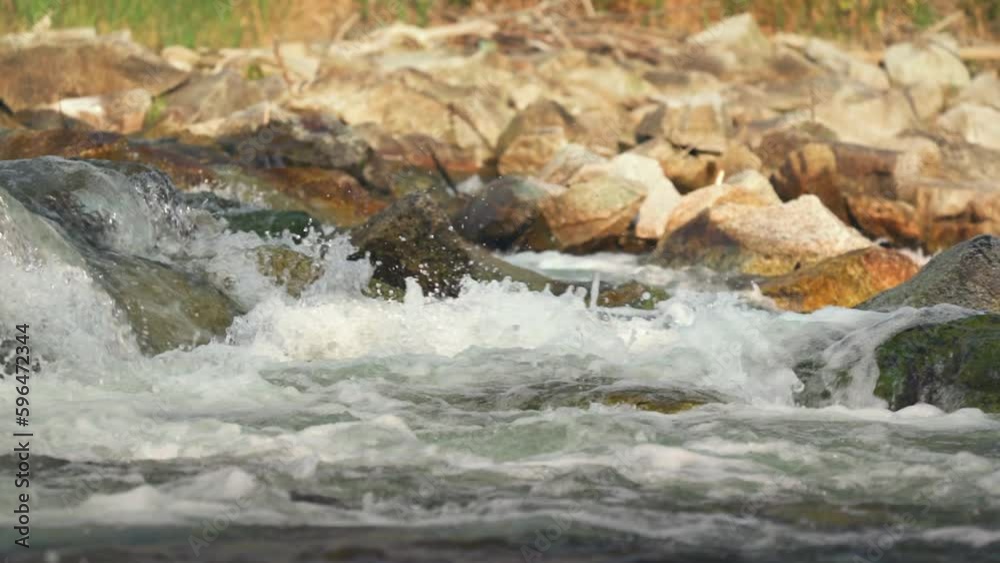 River flowing over rocks cascade on sunny day, closeup detail, slow motion video River flowing over rocks cascade on sunny day, closeup detail, slow motion video