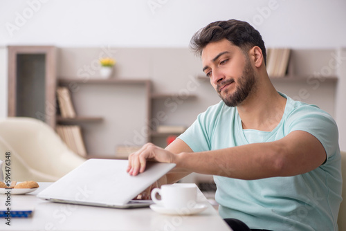 Young male freelancer working from home
