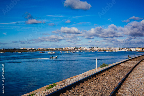 Faro city in algarve portugal, view over Ria Formosa nature park with the railroad crossing © Photo Art