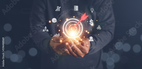 Hands holding virtual bullseye target dart board to business goals, Setup objectives and target for business investment concept, Digital marketing, Financial and banking, Digital link tech.