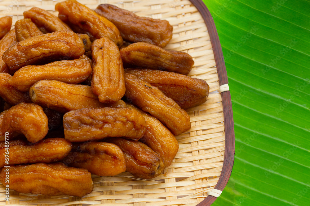 Fototapeta premium Sun-dried bananas in bamboo weave plate