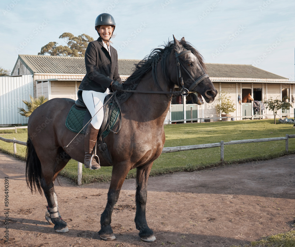 My trusty steed. Full length shot of a young female jockey riding her horse outside on the ranch. My trusty steed. Full length shot of a young female jockey riding her horse outside on the ranch.