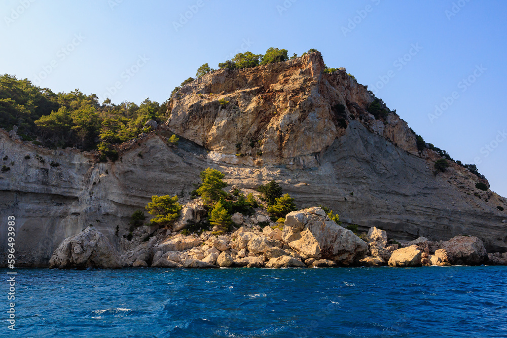 View of the rocky shore from the sea. Mediterranean Sea in Turkey. Popular tourist places. Background View of the rocky shore from the sea. Mediterranean Sea in Turkey. Popular tourist places. Background