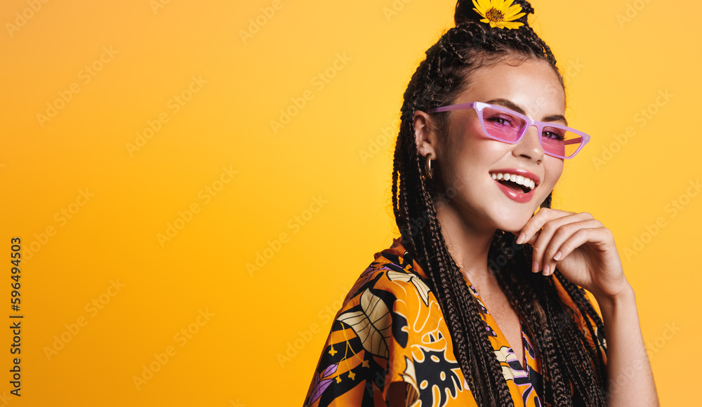 Beautiful brunette woman, 25 years, stylish girl in summer look, with sunglasses and dress, looks coquettish at camera, isolated on yellow background Beautiful brunette woman, 25 years, stylish girl in summer look, with sunglasses and dress, looks coquettish at camera, isolated on yellow background