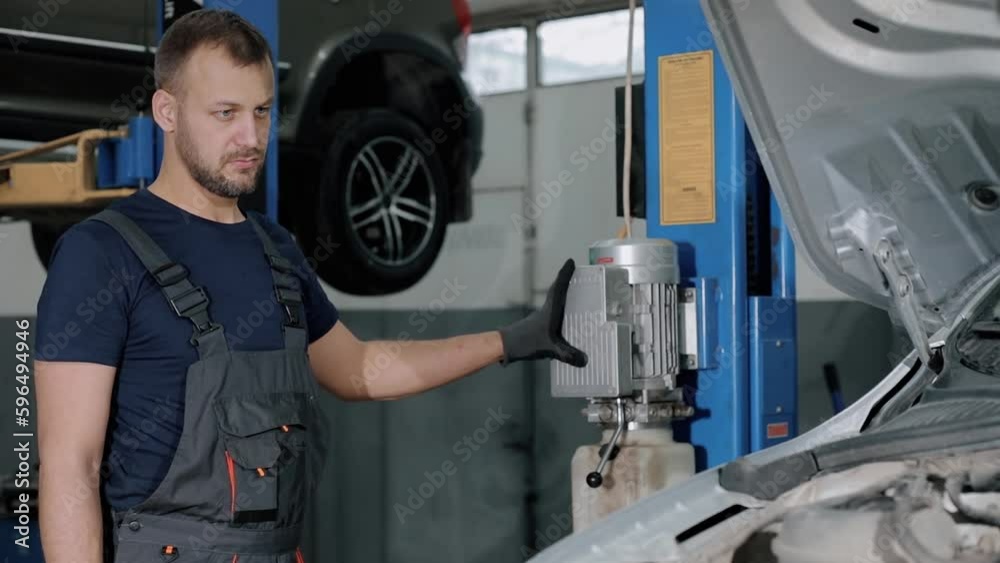 Large hydraulic jack. auto mechanic repairs the gearbox in a modern car. professional car service. Replacement of warranty parts. Large hydraulic jack. auto mechanic repairs the gearbox in a modern car. professional car service. Replacement of warranty parts.
