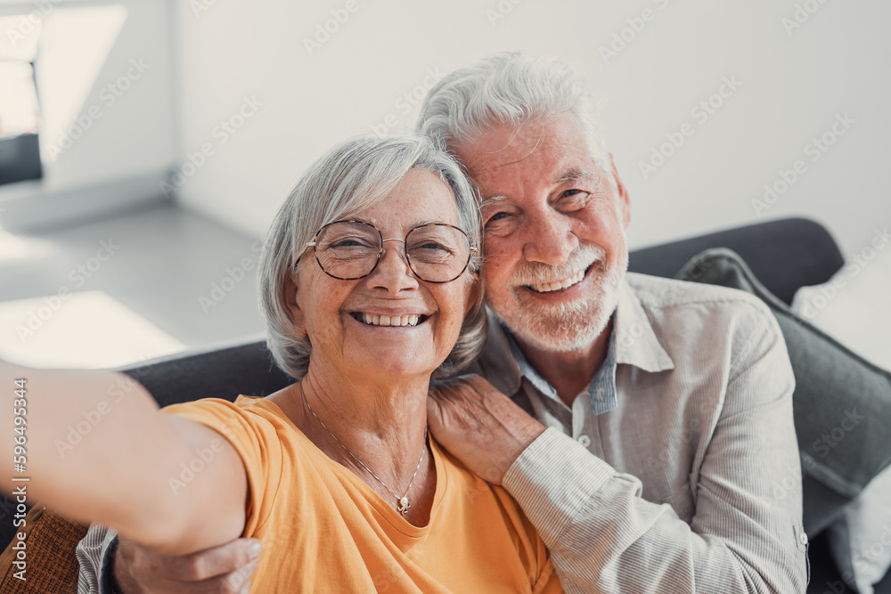 Head shot portrait happy senior couple taking selfie, having fun with phone cam, smiling aged wife and husband hugging, looking at camera, posing for photo, aged man vlogger recording video. Head shot portrait happy senior couple taking selfie, having fun with phone cam, smiling aged wife and husband hugging, looking at camera, posing for photo, aged man vlogger recording video.