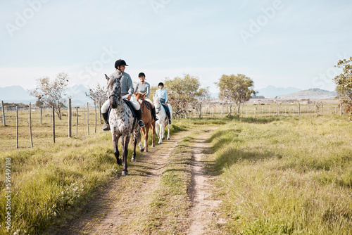 There is no other feeling in the world to compare. Shot of three attractive young women horse riding on a farm.