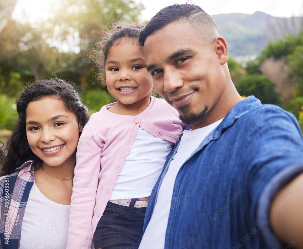 Fototapeta premium Family means we stick with each other through everything. Shot of a young family happily bonding together outside.