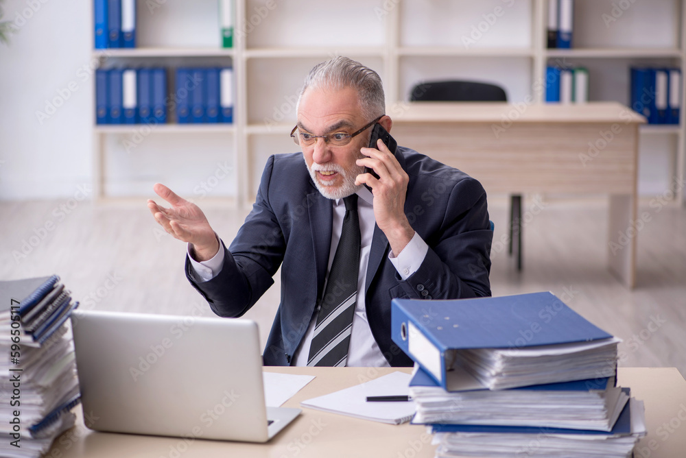 Old male employee and too much work at workplace Old male employee and too much work at workplace