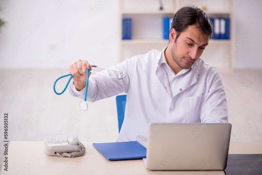 Young male doctor working in the clinic Young male doctor working in the clinic