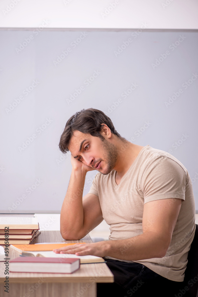 Young male student sitting in the classroom Young male student sitting in the classroom