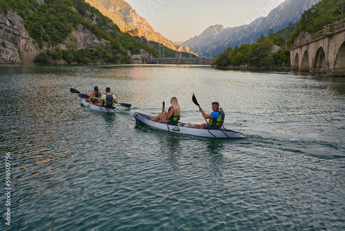 A group of friends enjoying having fun and kayaking while exploring the calm river, surrounding forest and large natural river canyons