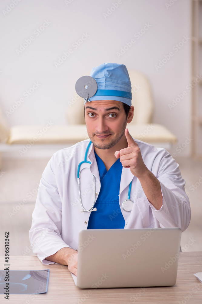 Young male doctor otologist working in the clinic Young male doctor otologist working in the clinic