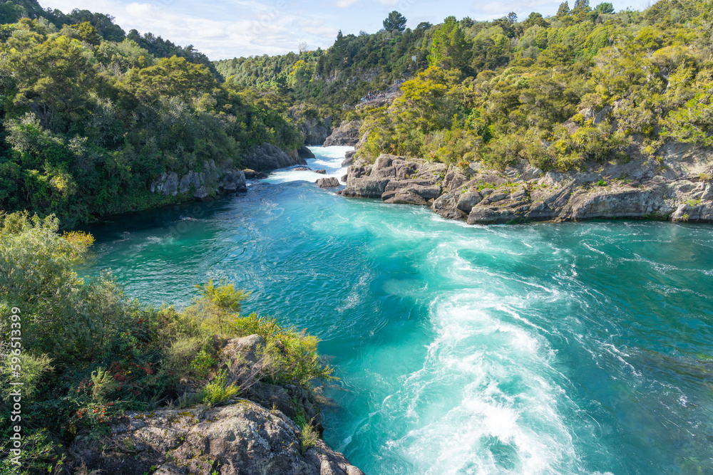 Swirling and surging river water through rocky ravine Swirling and surging river water through rocky ravine