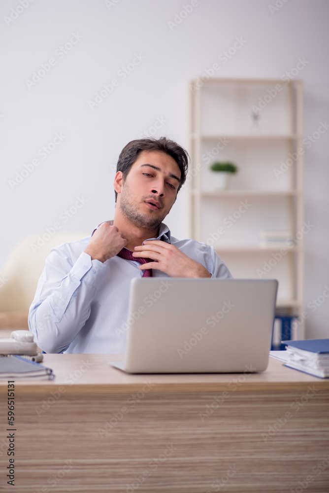 Young male employee working in the office Young male employee working in the office
