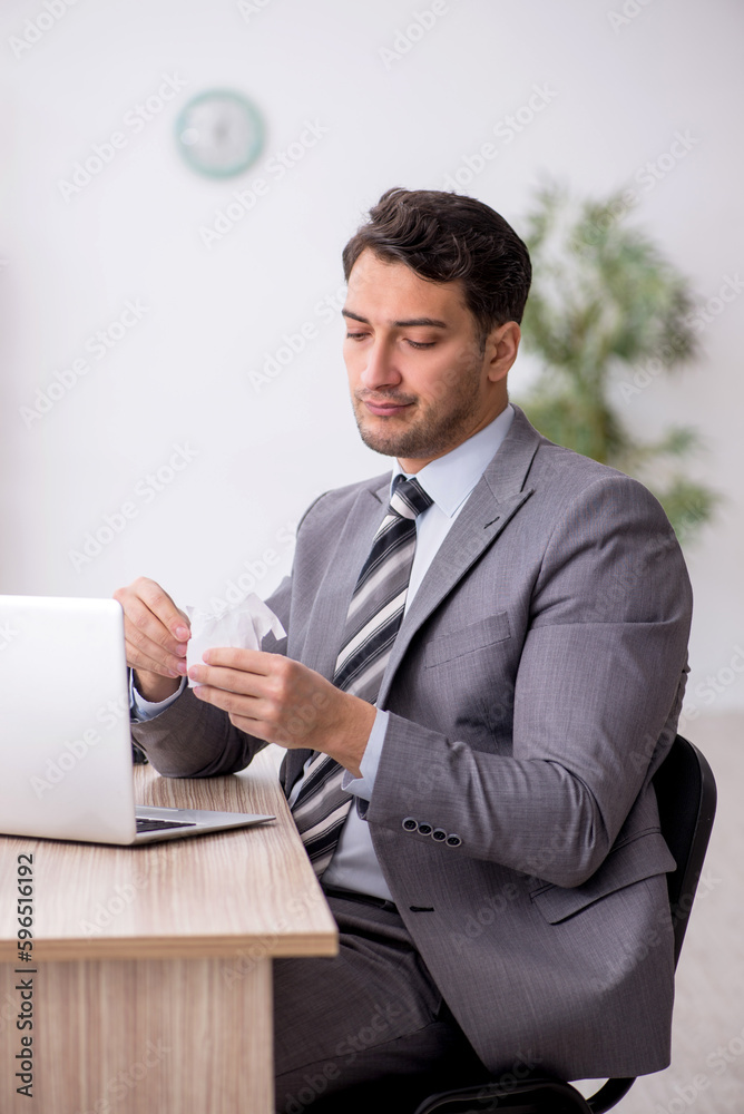 Young male employee working in the office Young male employee working in the office
