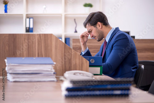 Young male employee working in the office