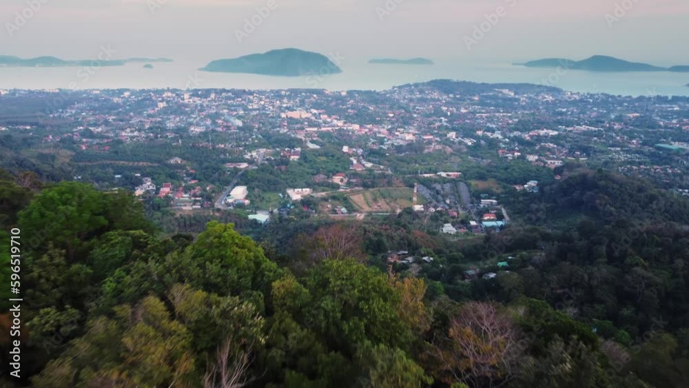 Aerial view of coastal city built between ocean and mountain ridge filmed at summer day. Drone landscape of touristic town on the shore of sea next to cliffs in Thailand. Travelling to exotic country. Aerial view of coastal city built between ocean and mountain ridge filmed at summer day. Drone landscape of touristic town on the shore of sea next to cliffs in Thailand. Travelling to exotic country.